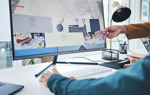 Website maintenance: Monitor with a person touching the keyboard